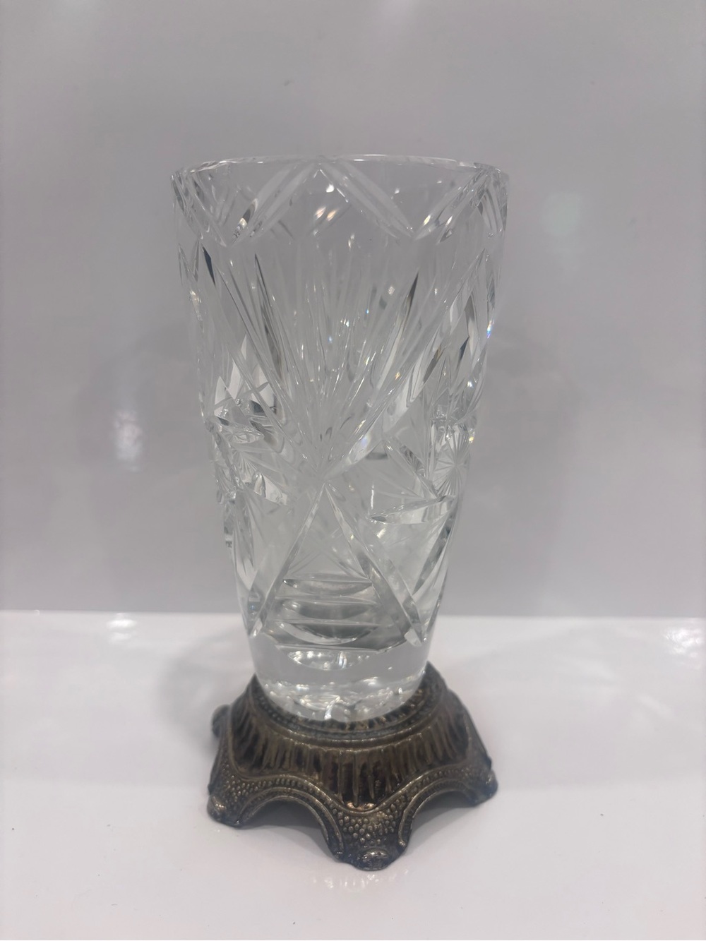 Vintage cut crystal vase mounted in an ornate metal base 8”